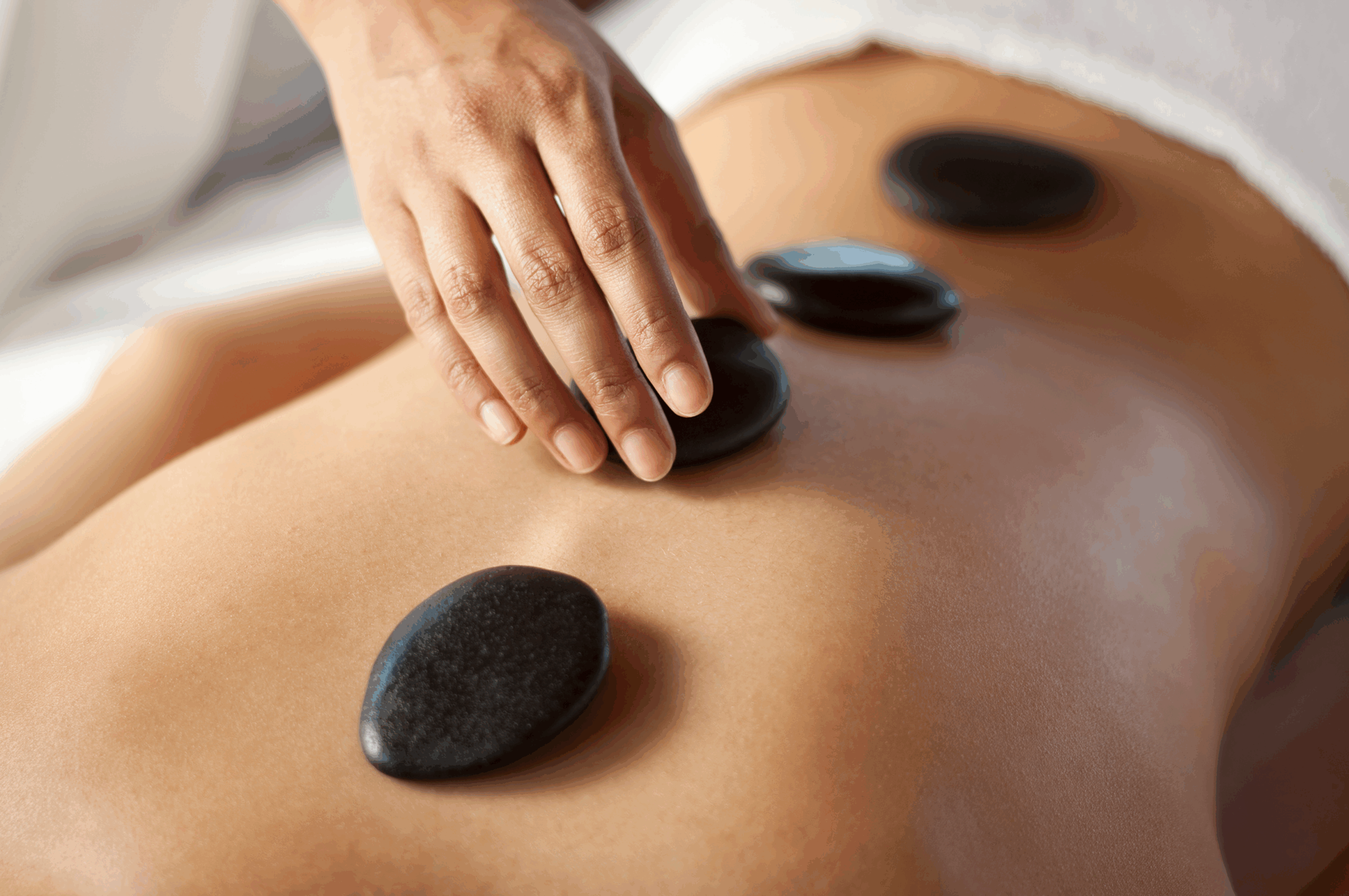 Hot stone massage on person's back.